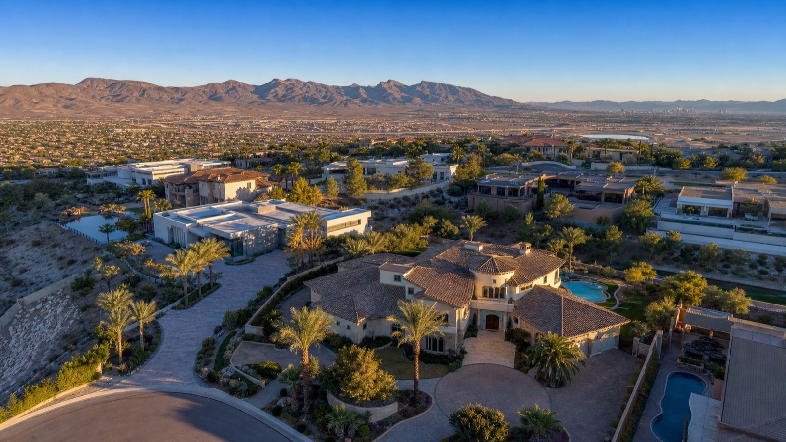 Henderson guard-gated community clubhouse and pool deck with palm trees and Black Mountain backdrop