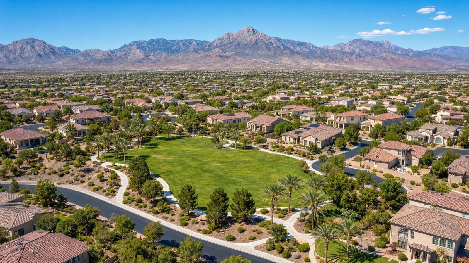 Mountain's Edge village within Enterprise showing newer-construction single-family homes with desert landscaping and the Spring Mountains in the background