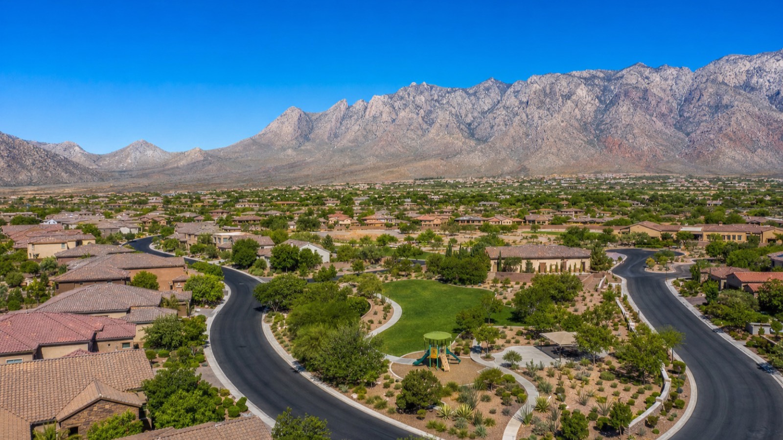 Rhodes Ranch gated golf-community in Enterprise south Las Vegas with mature landscape, single-family detached inventory, and the Spring Mountains in the background