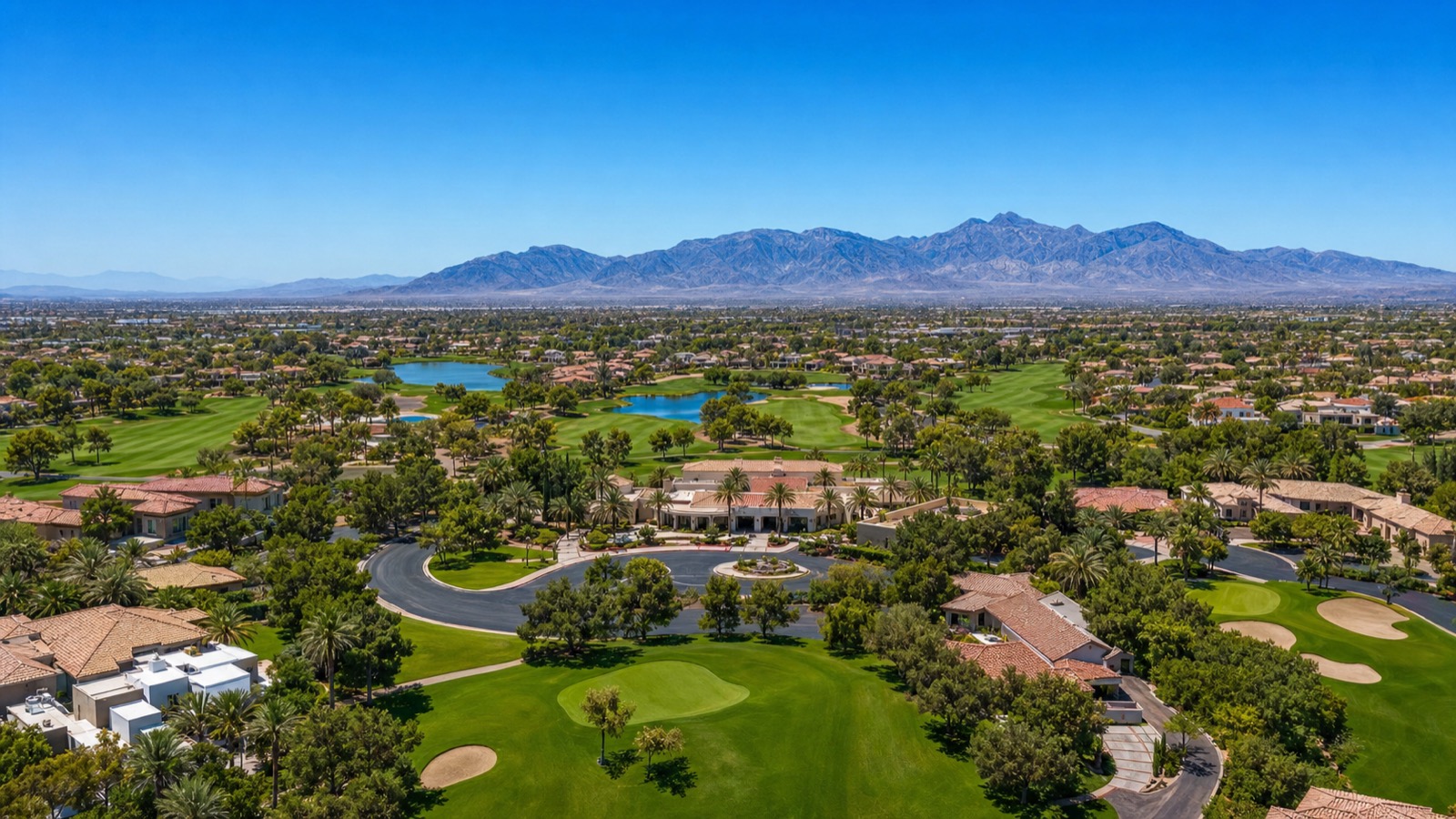 Painted Desert northwest Las Vegas guard-gated country club community mature streetscape with palm trees and Mediterranean homes