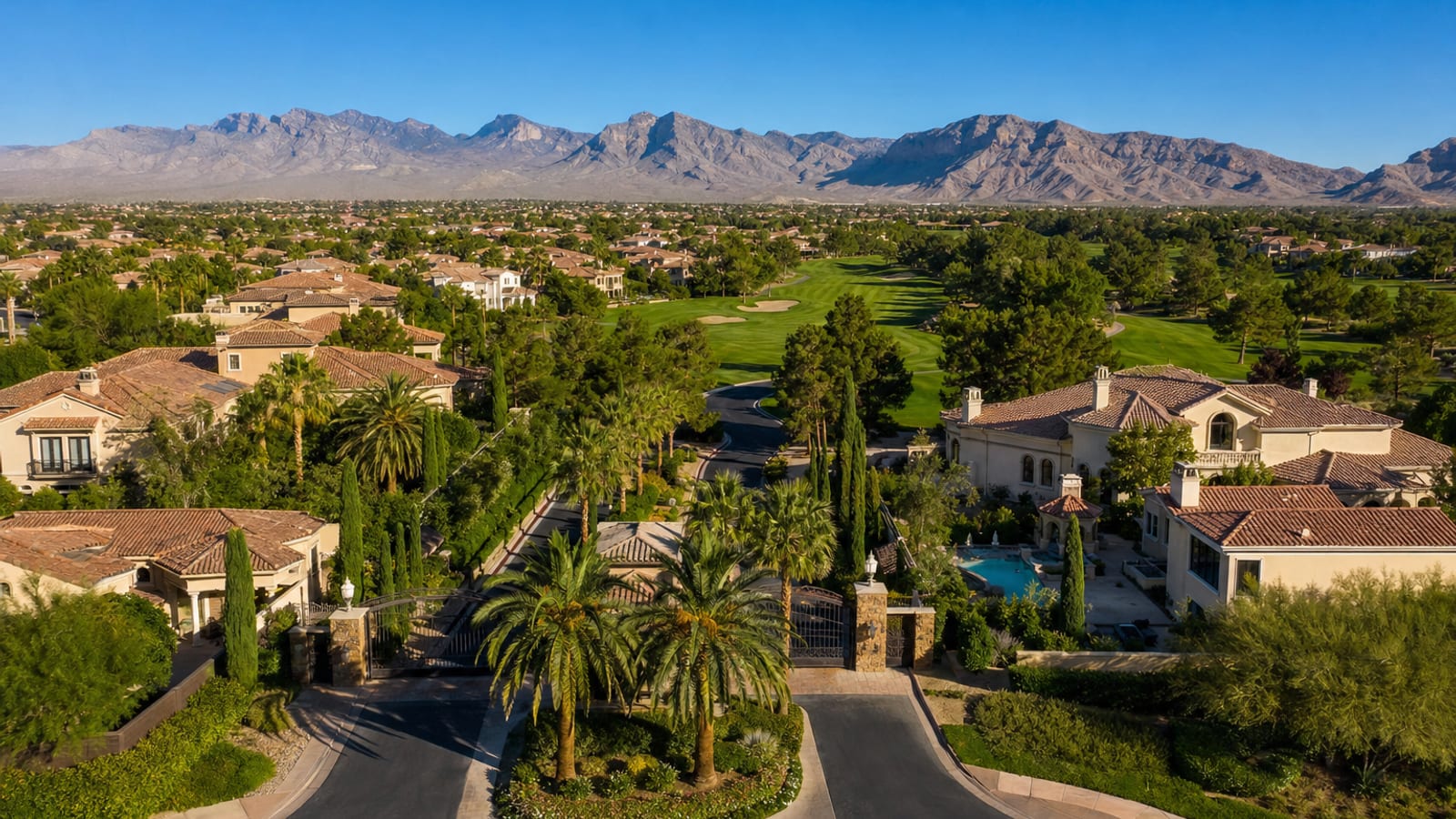 Queensridge guard-gated luxury neighborhood streetscape with Mediterranean estate homes and mature established landscaping