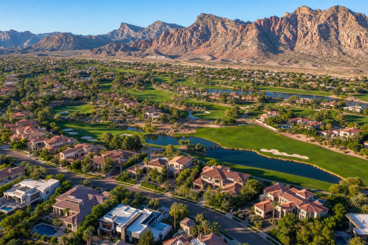 Aerial view of Red Rock Country Club in western Summerlin showing dozens of private backyard pools, the championship golf course, and the Spring Mountains backdrop — a representative concentration of luxury pool homes in Las Vegas