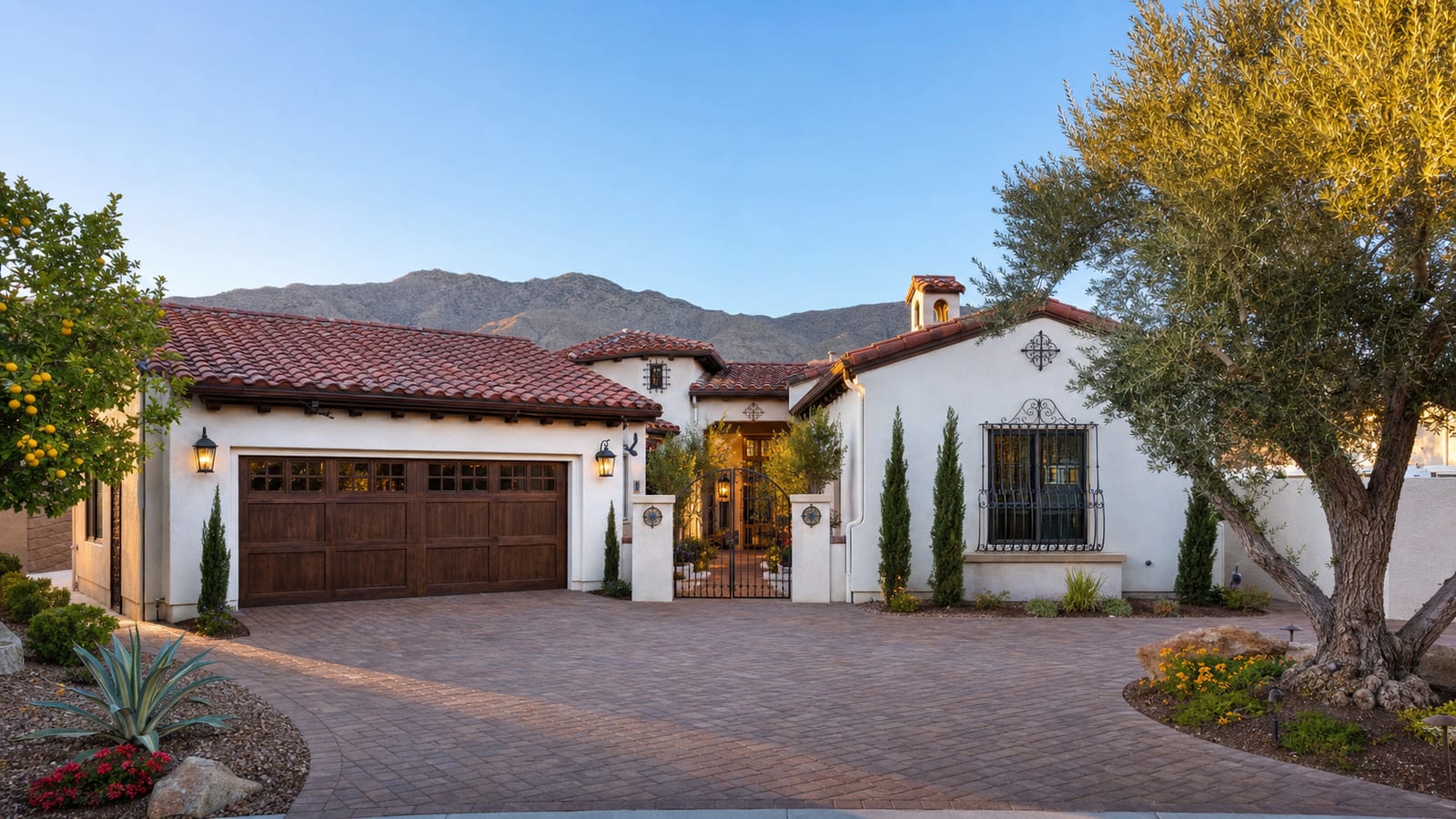 Spanish Trail Las Vegas Spanish revival custom estate home with terracotta tile roof mature landscaping and warm stucco facade