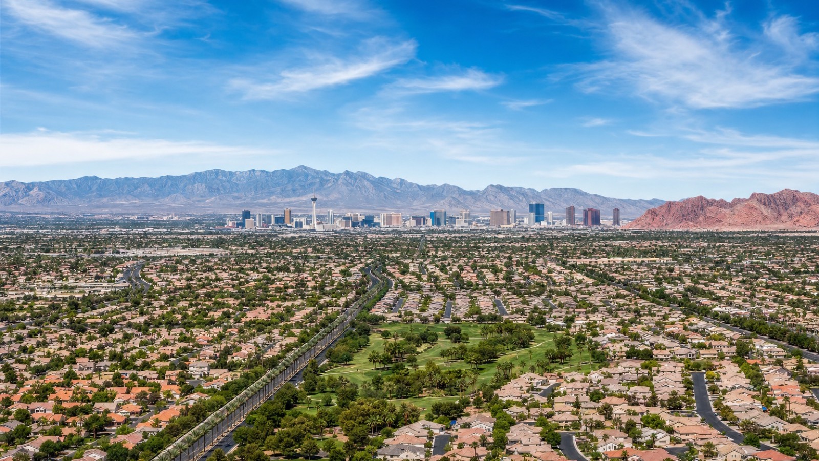 East Las Vegas valley overview from above showing Sunrise Manor residential grids with Sunrise Mountain and Frenchman Mountain forming the eastern horizon