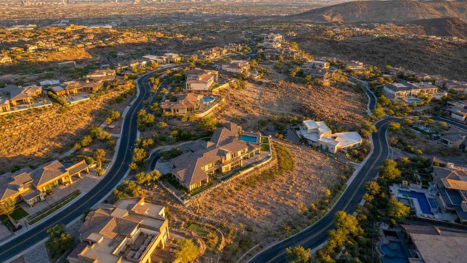 Aerial view of The Mesa luxury village in Summerlin West with custom estate homes and Red Rock Canyon ridgeline in the distance — Las Vegas, Nevada